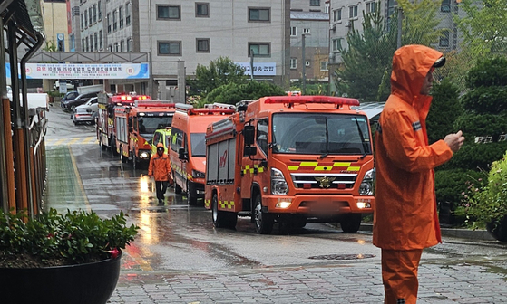 Officials search a high school in Asan, South Chungcheong, after receiving a report that bombs have been planted inside the campus on Oct. 13. [NEWS1]