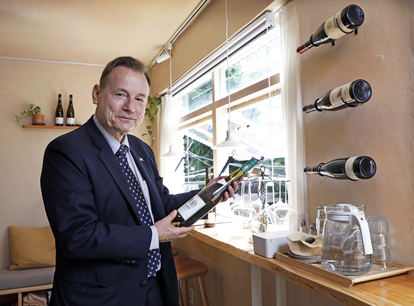 German Ambassador Georg Schmidt highlights Germany’s wine culture, holding a bottle of Riesling at Grund in eastern Seoul on Sept. 22. [PARK SANG-MOON]