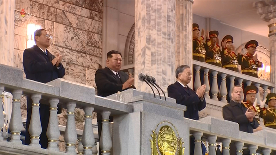 Chinese Premier Li Qiang is seen standing on the right of North Korean leader Kim Jong-un during the celebrations for the 80th anniversary of the founding of the Workers’ Party held in Pyongyang on Oct. 10. [KOREA CENTRAL TV]