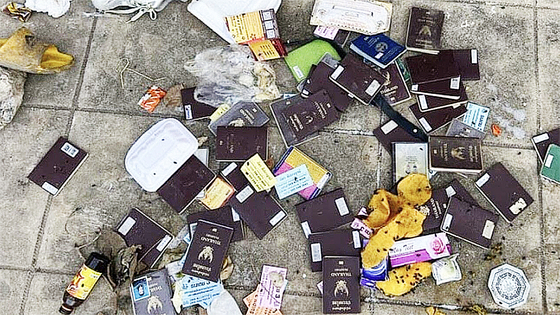 A street photo from Poipet, Cambodia, posted on a Thai online community last June, shows a pile of Thai and other foreign passports scattered around a trash can [SCREEN CAPTURE]