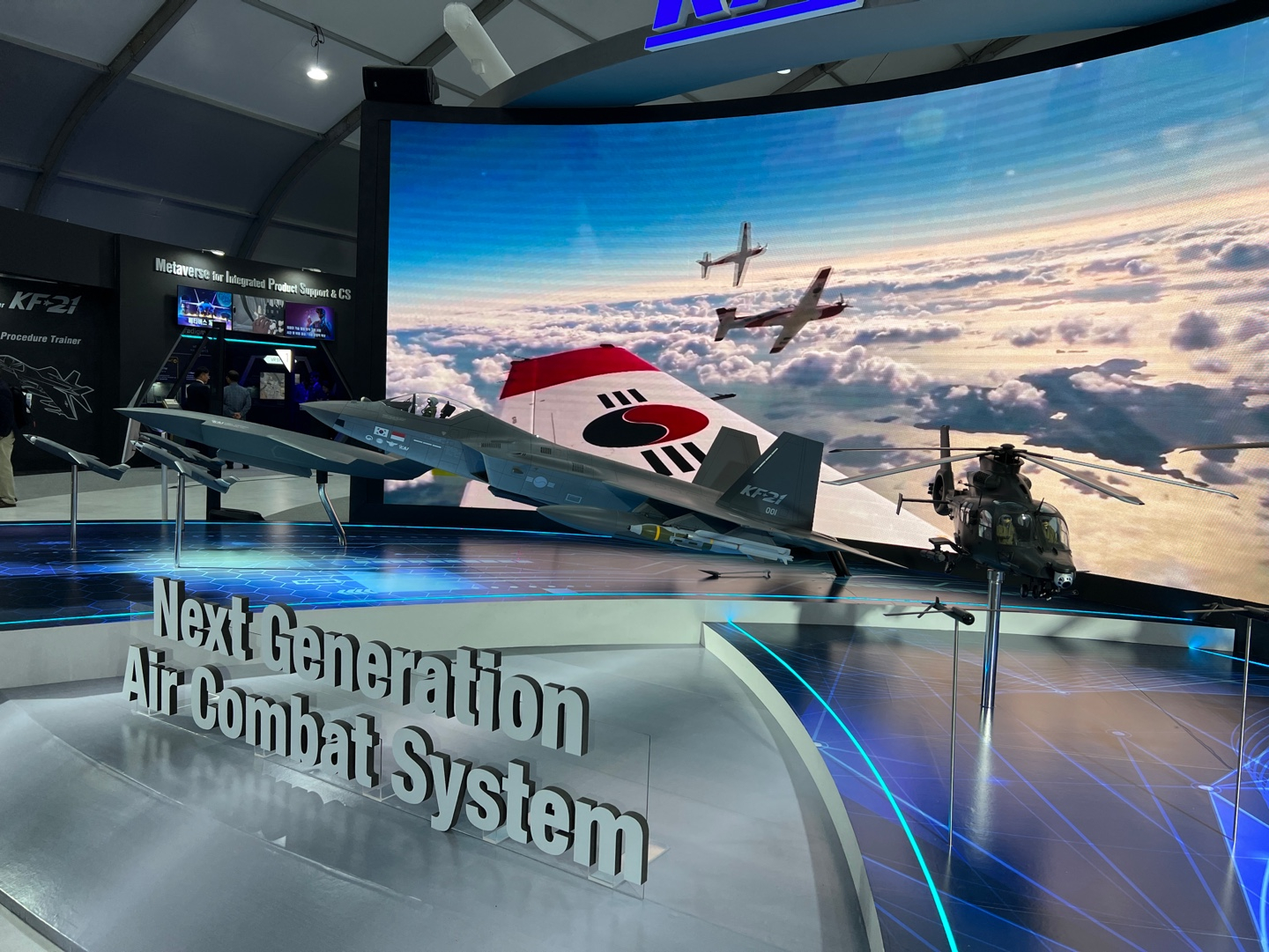 Models of Korea Aerospace Industries' KF-21 multirole fighter, right, and unmanned combat aircraft, left, are on display at the company's showroom at the 2023 Seoul ADEX. [MICHAEL LEE]