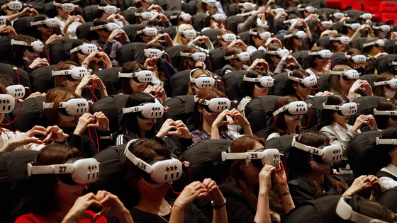 Audiences react as they watch boy band Tomorrow X Together's ″Heart Attack″ VR film at the Megabox Coex branch in southern Seoul. [AMAZE]