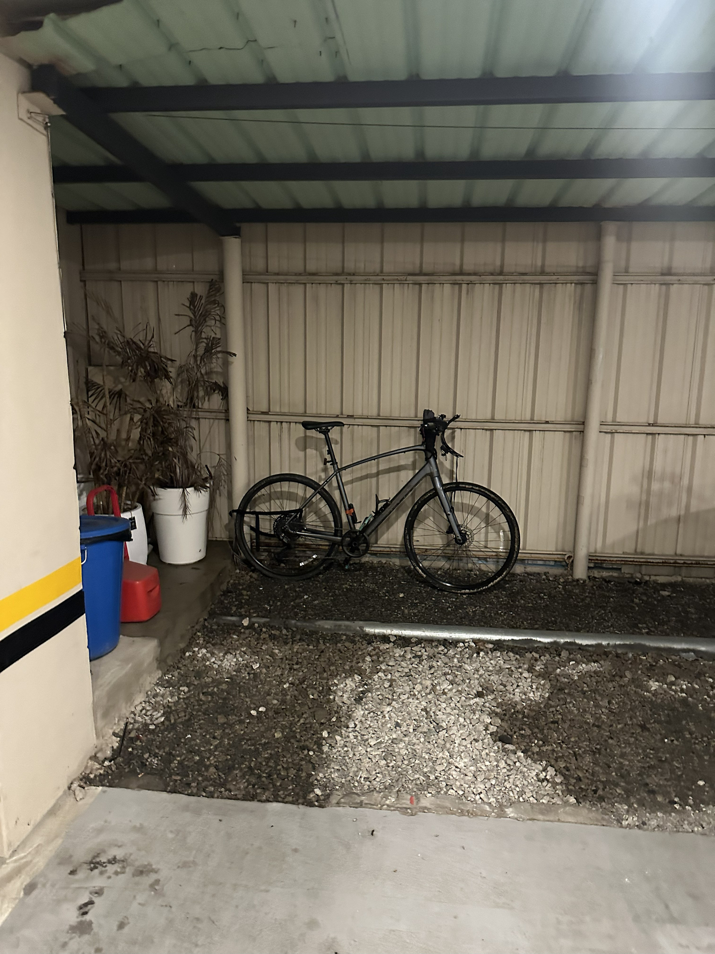 A covered space for bikes at the back of a parking garage at a motel in Cheongju, North Chungcheong on Sept. 28.  [JIM BULLEY]