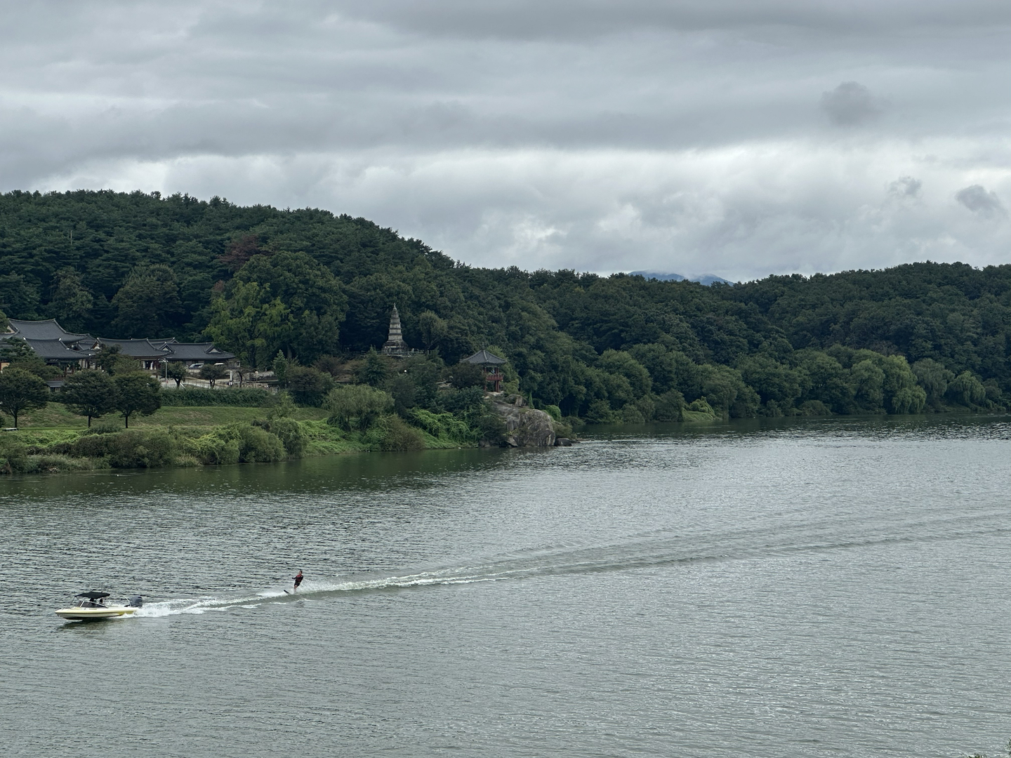 A waterskier passes in front of Silleuksa, a Buddhist temple outside Yeoju, Gyeonggi, on Sept. 28.  [JIM BULLEY]