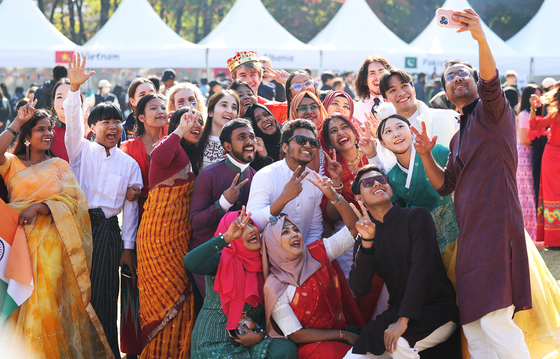 International students pose for a photograph during an event held at Ajou University in Suwon on Nov. 17, 2024. [YONHAP]  