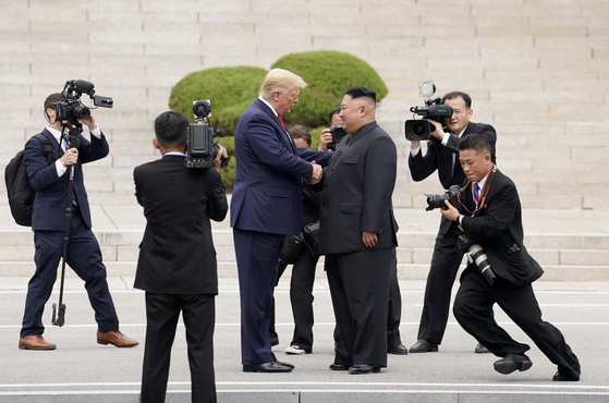 U.S. President Donald Trump meets with North Korean leader Kim Jong-un at the demilitarized zone separating the two Koreas, in Panmunjom, South Korea, June 30, 2019. [REUTERS/YONHP]
