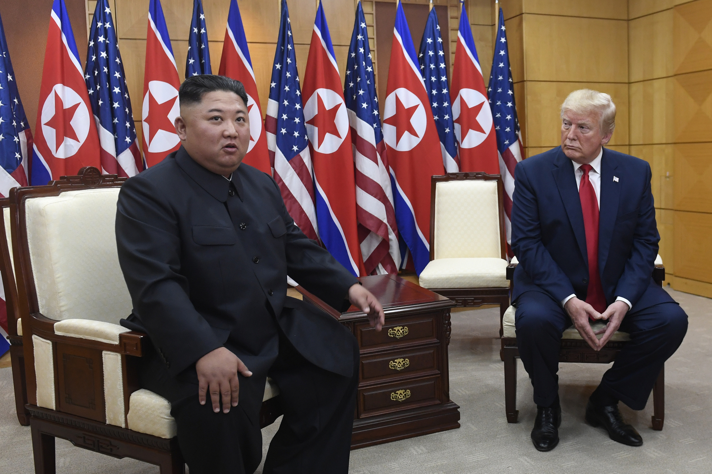 U.S. President Donald Trump, right, listens as North Korean leader Kim Jong-un speaks during their bilateral meeting inside the Freedom House at the border village of Panmunjom in the demilitarized zone on June 30, 2019. [AP/YONHAP]