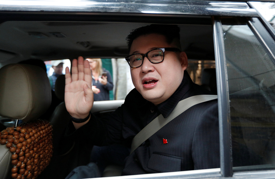 Howard X, an Australian impersonating North Korean leader Kim Jong-un, leaves the La Paix Hotel in a car while escorted by police in Hanoi, Vietnam on Feb. 25, 2019. [REUTERS/YONHAP]