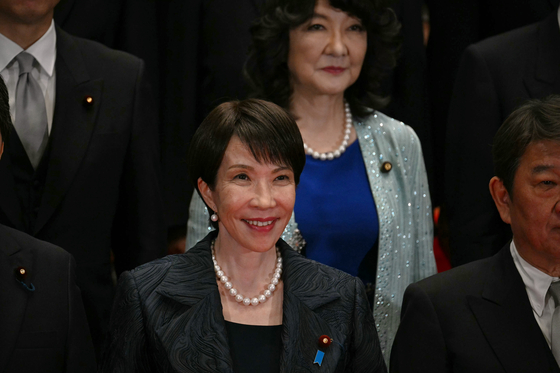 Japan's new Prime Minister Sanae Takaichi, center first row, poses during a photo session with members of her cabinet at the prime minister's official residence in Tokyo on Oct. 21. [AP/YONHAP]