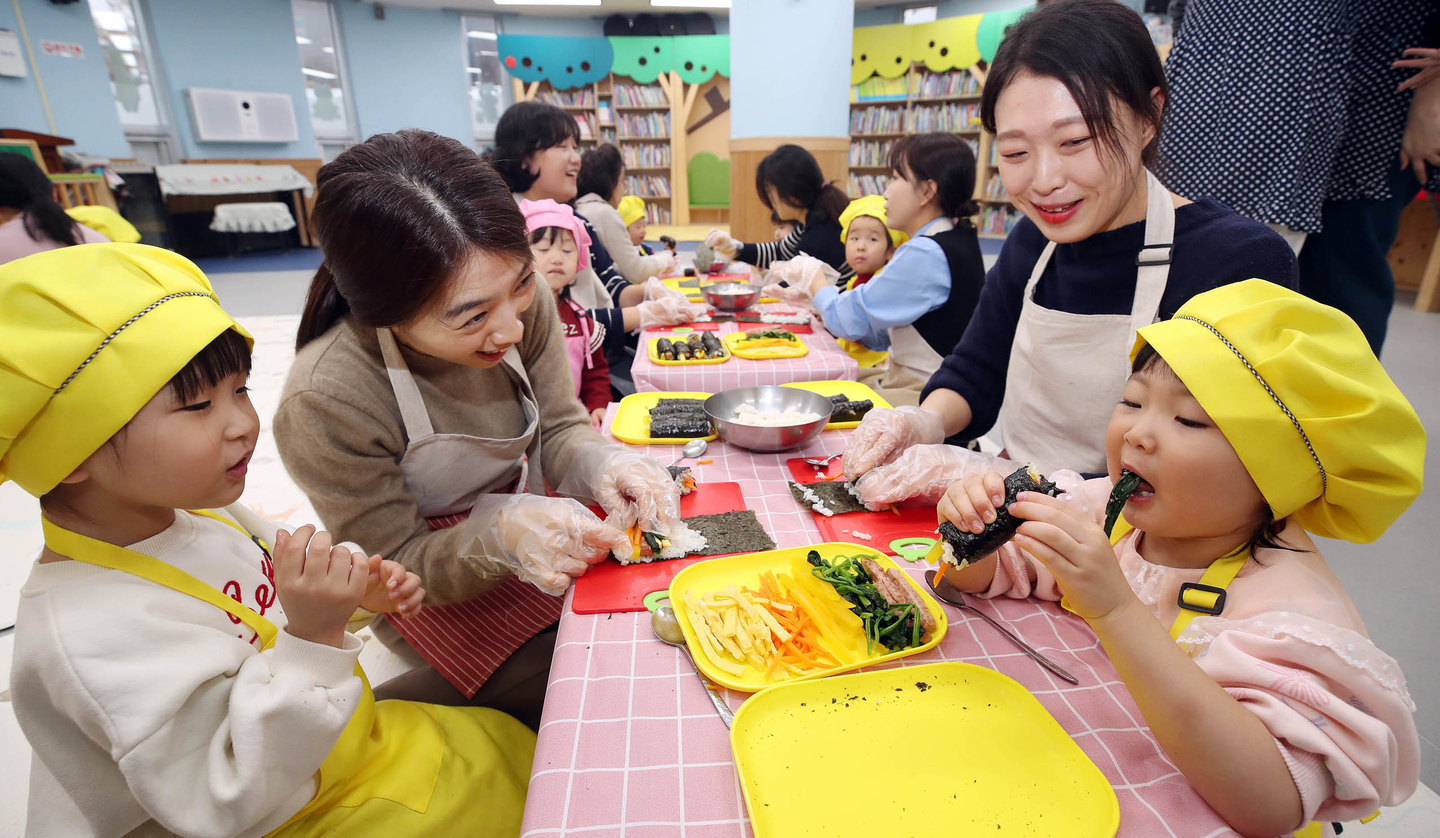 Children make gimbap with their mothers during a special cooking class at a day care center in Buk District, Gwangju, on Dec. 6, 2024. [GWANGJU'S BUK DISTRICT OFFICE] 