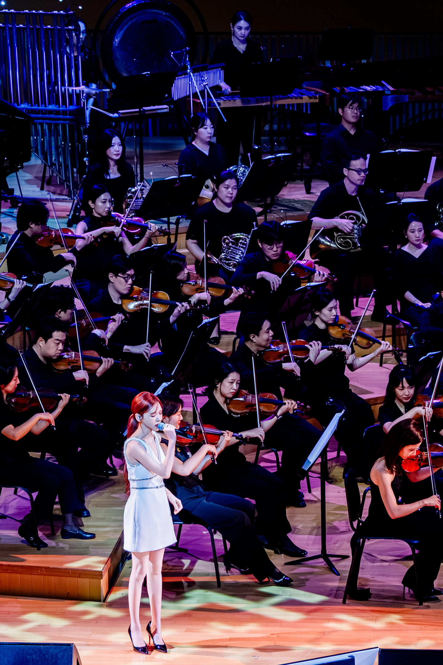 In February, the Seoul Philharmonic Orchestra performed orchestral arrangements of songs by SM Entertainment artists, arranged by SM Classics. In this image, girl group Red Velvet’s Wendy sings as a featured soloist. [SM ENTERTAINMENT]