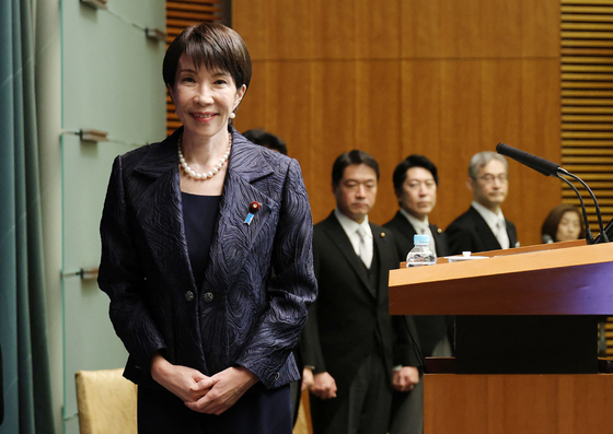 Japan's new Prime Minister Sanae Takaichi poses for photos at the beginning of her first press conference as Japanese leader at the prime minister's office in Tokyo on Oct. 21. [AFP/YONHAP]