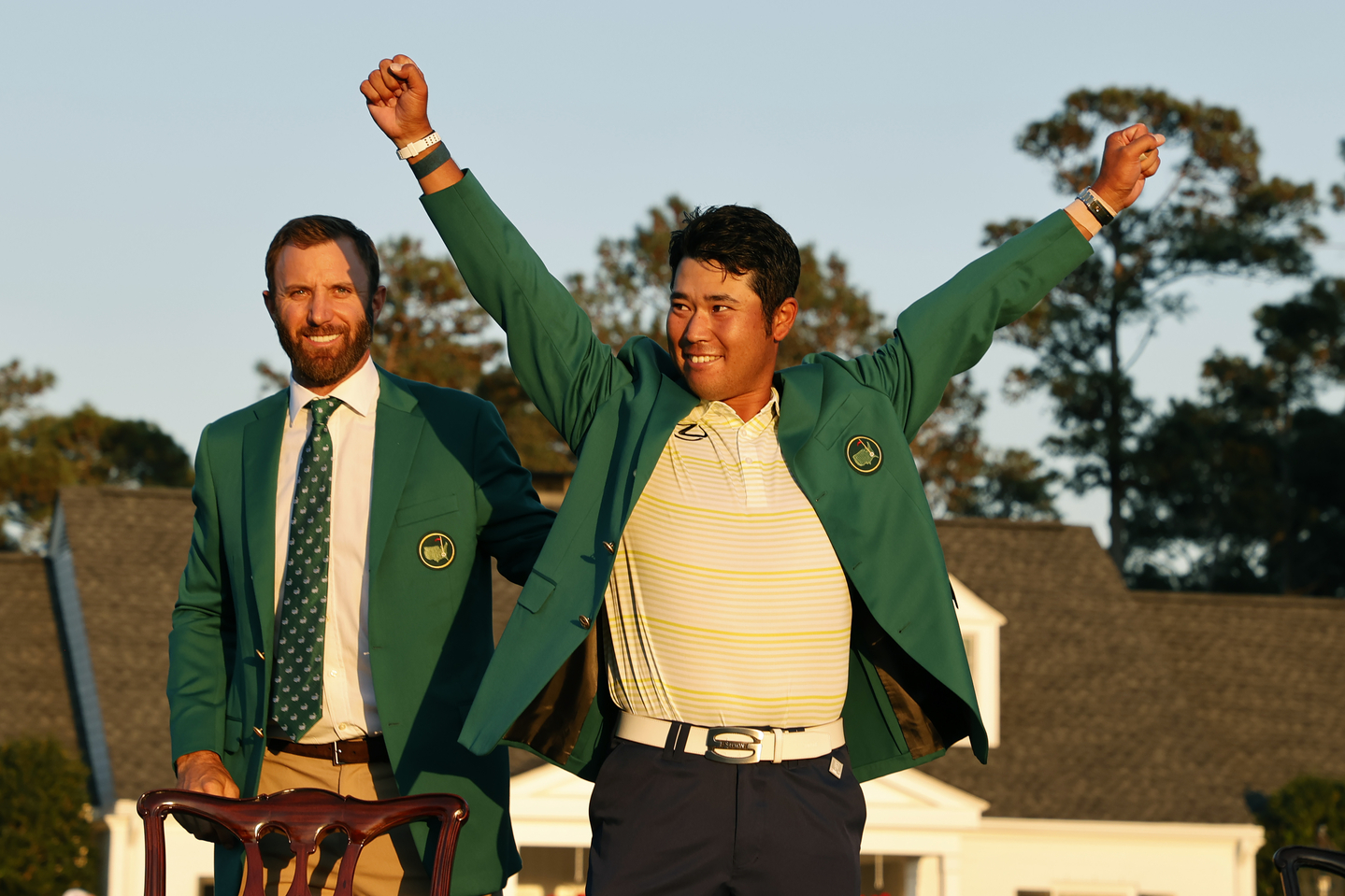 Hideki Matsuyama of Japan is awarded the Green Jacket by Masters champion Dustin Johnson after winning the Masters at Augusta National Golf Club, April 11, 2021. [ASIA-PACIFIC AMATEUR CHAMPIONSHIP]