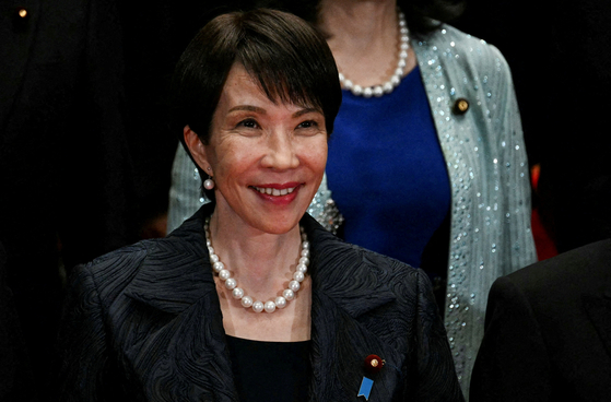 Japan's new prime minister, Sanae Takaichi, poses during a photo session with members of her cabinet at the prime minister's office in Tokyo on Oct. 21. [REUTERS/YONHAP]