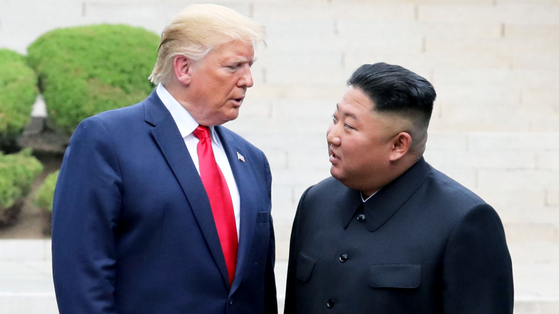 North Korean leader Kim Jong-un, right, and U.S. President Donald Trump converse during a summit at Panmunjom on Jan. 1, 2020. [YONHAP]