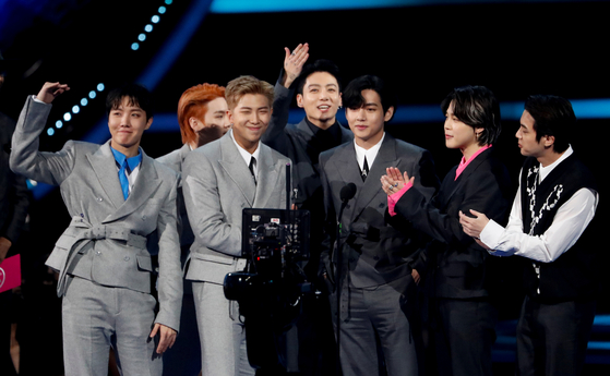 K-pop boy band BTS receives an award for Favourite Pop Song at the Annual American Music Awards at the Microsoft Theatre in Los Angeles, California on Nov. 21, 2021. [REUTERS/YONHAP]