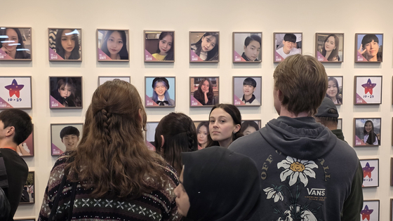 Family members of victims of the Oct. 29, 2022 Itaewon crowd crush look at photos of the deceased at the ″House of Stars″ memorial for the victims in Jongno District, central Seoul on Oct. 26. [KIM CHANG-YONG]