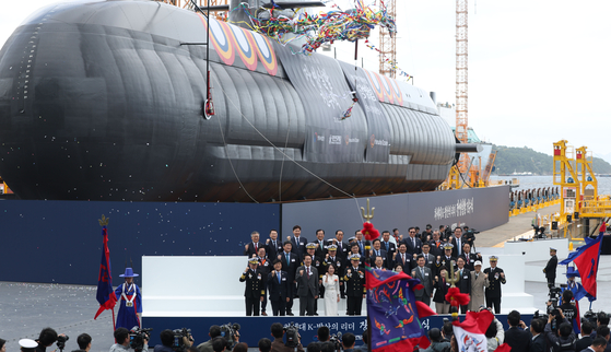 Hanwha Ocean executives pose for a photo during the launching ceremony for the Jangbogo-III Batch-II submarine at the company's shipyard in Geoje, South Gyeongsang, on Oct. 22. [YONHAP]