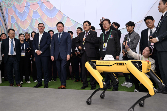 SK Group Chairman Chey Tae-won, third from front left, and Amazon Web Services (AWS) CEO Matt Garman, second from front left, observe Hyundai Motor's four-legged robot Spot at the K-Tech Showcase in Gyeongju, North Gyeongsang, on Oct. 28. [JOINT PRESS CORPS]