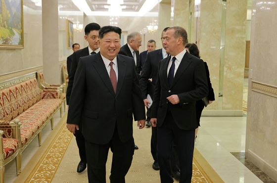 North Korean leader Kim Jong-un, left, meets with Dmitry Medvedev, deputy chairman of Russia’s Security Council, in Pyongyang on Oct. 10 to discuss ways to strengthen bilateral alliance relations, the state-run Rodong Sinmun reported on Oct. 11. [RODONG SINMUN]