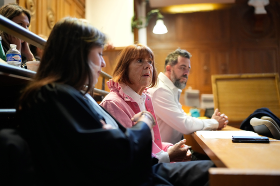 Gisele Pelicot, center, sits in the courtroom during the appeals trial in the case of a man challenging his conviction, less than a year after the landmark verdict in a drugging and rape trial that shook France, Oct. 9, in Nimes, southern France. [AP/YONHAP]