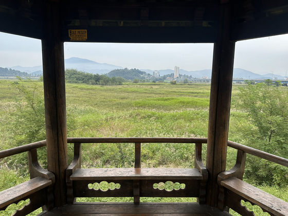 Rest areas, like this one in Daesan Village, South Gyeongsang, on Oct. 2, are common sights along the Nakdong River. In the top left corner, an advertisement for a bike pickup service is just visible. These services, advertised even in the most rural stretches of the river, are available if cyclists get stuck or stranded. [JIM BULLEY]