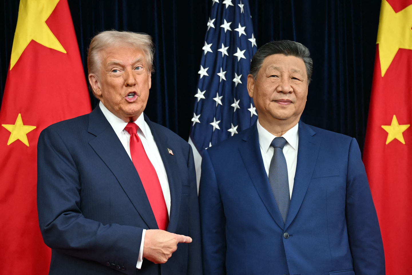 U.S. President Donald Trump, left, and China's President Xi Jinping greet each other as they arrive for talks at the Gimhae Air Base, located next to the Gimhae International Airport in Busan on Oct. 30. Donald Trump and Chinese leader Xi Jinping are set to seek a truce in their bruising trade war on Oct. 30, with the U.S. president predicting a "great meeting" but Beijing being more circumspect. [AFP/YONHAP]