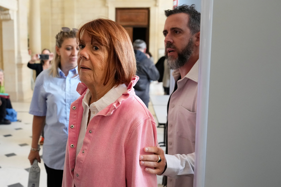 Gisele Pelicot followed by her son Florian Pelicot leave the courtroom during the appeals trial in the case of a man challenging his conviction, less than a year after the landmark verdict in a drugging and rape trial that shook France, Oct. 9, in Nimes, southern France. [AP/YONHAP]