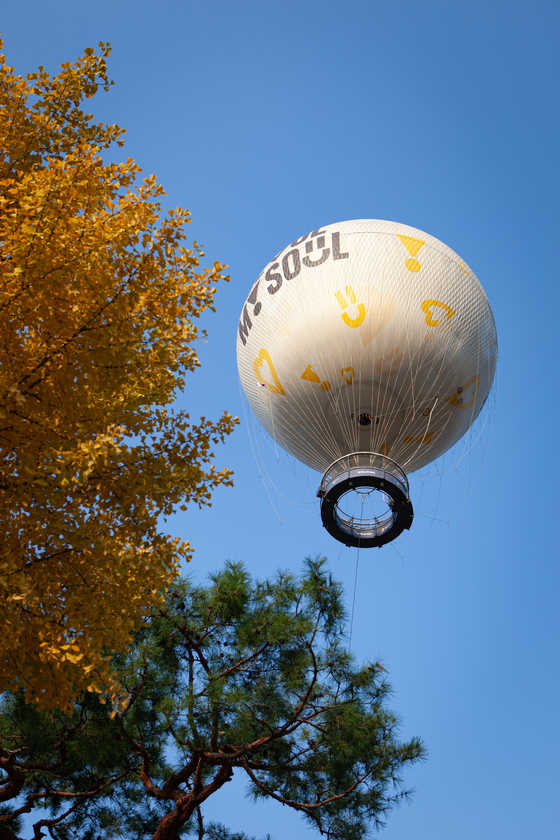 The Seouldal balloon floats above the turning leaves at Yeouido Hangang Park in western Seoul on Oct. 28. [MICHAEL LEE]