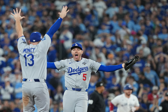 Los Angeles Dodgers first baseman Freddie Freeman (5) reacts with third baseman Max Muncy (13) after defeating the Toronto Blue Jays in the eleventh inning for game seven of the 2025 MLB World Series at Rogers Centre in Toronto, Ontario, on Nov. 1. [REUTERS/YONHAP]