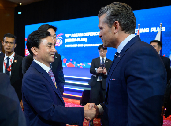 Defense Minister Ahn Gyu-back, left, and U.S. Defense Secretary Pete Hegseth shake hands during the Asean Defense Ministers' Meeting-Plus in Kuala Lumpur on Nov. 1 in this photo provided by the Defense Ministry. [YONHAP]