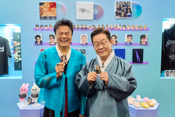 President Lee Jae Myung, right, and JYP Entertainment founder and co-chair of the newly established Presidential Committee on Popular Culture Exchange Park Jin-young pose for photos at the K-culture exhibition zone inside Kintex in Goyang, Gyeonggi, on Oct. 1. [PRESIDENTIAL OFFICE]