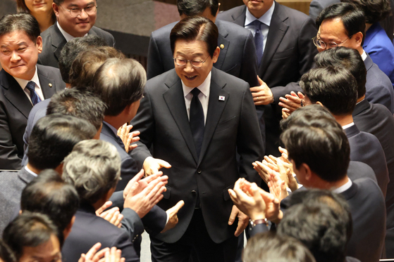 President Lee Jae Myung exits the main chamber of the National Assembly after delivering a budget speech as lawmakers applaud in Yeouido, western Seoul, on Nov. 4. [LIM HYUN-DONG]
