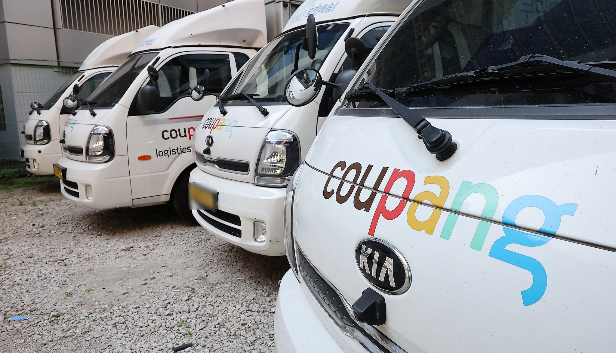 Coupang delivery vehicles are parked in a parking lot in Jung District, central Seoul, on June 3. [NEWS1]