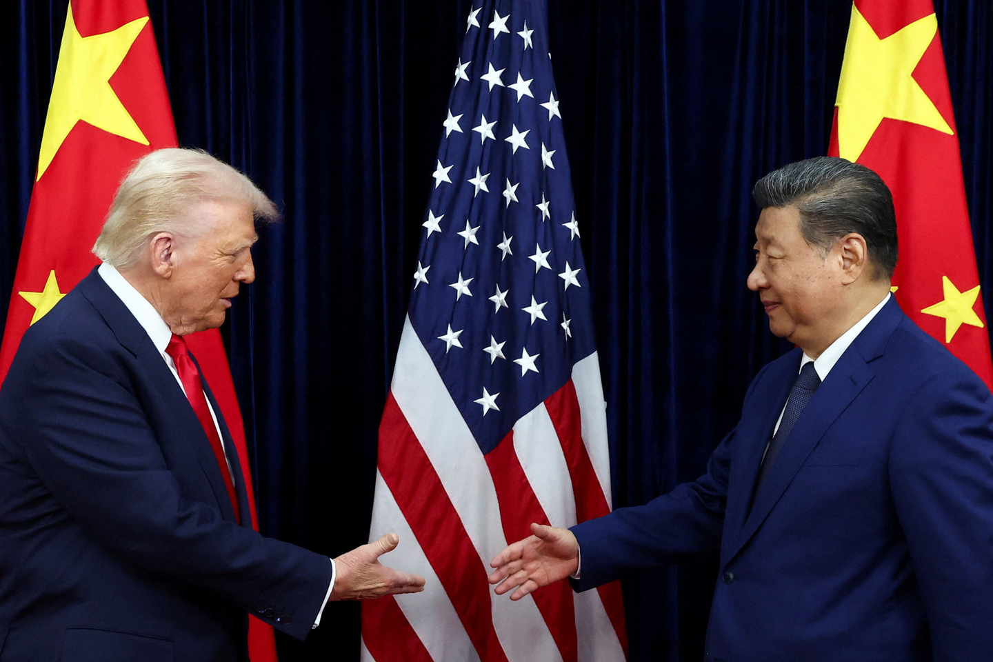 U.S. President Donald Trump shakes hands with Chinese President Xi Jinping as they hold a bilateral meeting at Gimhae International Airport, on the sidelines of the Asia Pacific Economic Cooperation (APEC) summit, in Busan, South Korea, October 30, 2025. [REUTERS/YONHAP]