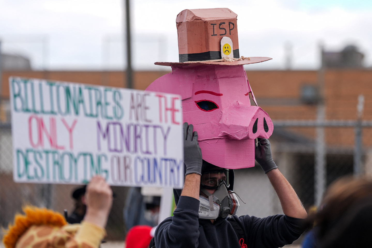 A demonstrator holds a cutout mask shaped as a pig during a protest near the Broadview ICE facility, after U.S. President Donald Trump ordered an increased federal law enforcement presence to assist in crime prevention, in the Chicago suburb of Broadview, Illinois, U.S., November 1, 2025. [REUTERS/YONHAP]
