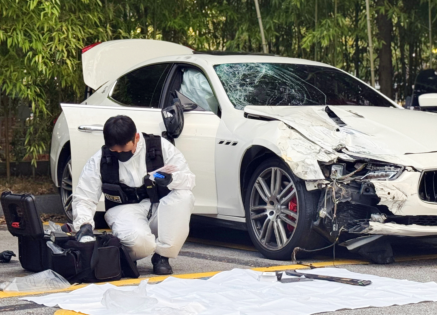 Officials from the National Forensic Service conduct a detailed inspection of the Maserati involved in the fatal hit-and-run at the Gwangju Seo Police Precinct on Sept. 25, 2024. [YONHAP]