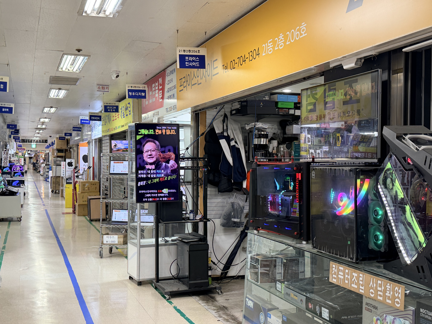 A store in Yongsan Electronics Market in central Seoul has screens featuring a photo of Nvidia CEO Jensen Huang, photshopped to hold a piece of fried chicken in his hand. [CHO YONG-JUN]