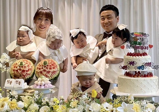 Military couple Captain Seo Hye-jeong, left, and Captain Kim Jin-su, right, hold their quintuplet babies during the children's first birthday party on Nov. 13, 2022. [YONHAP] 