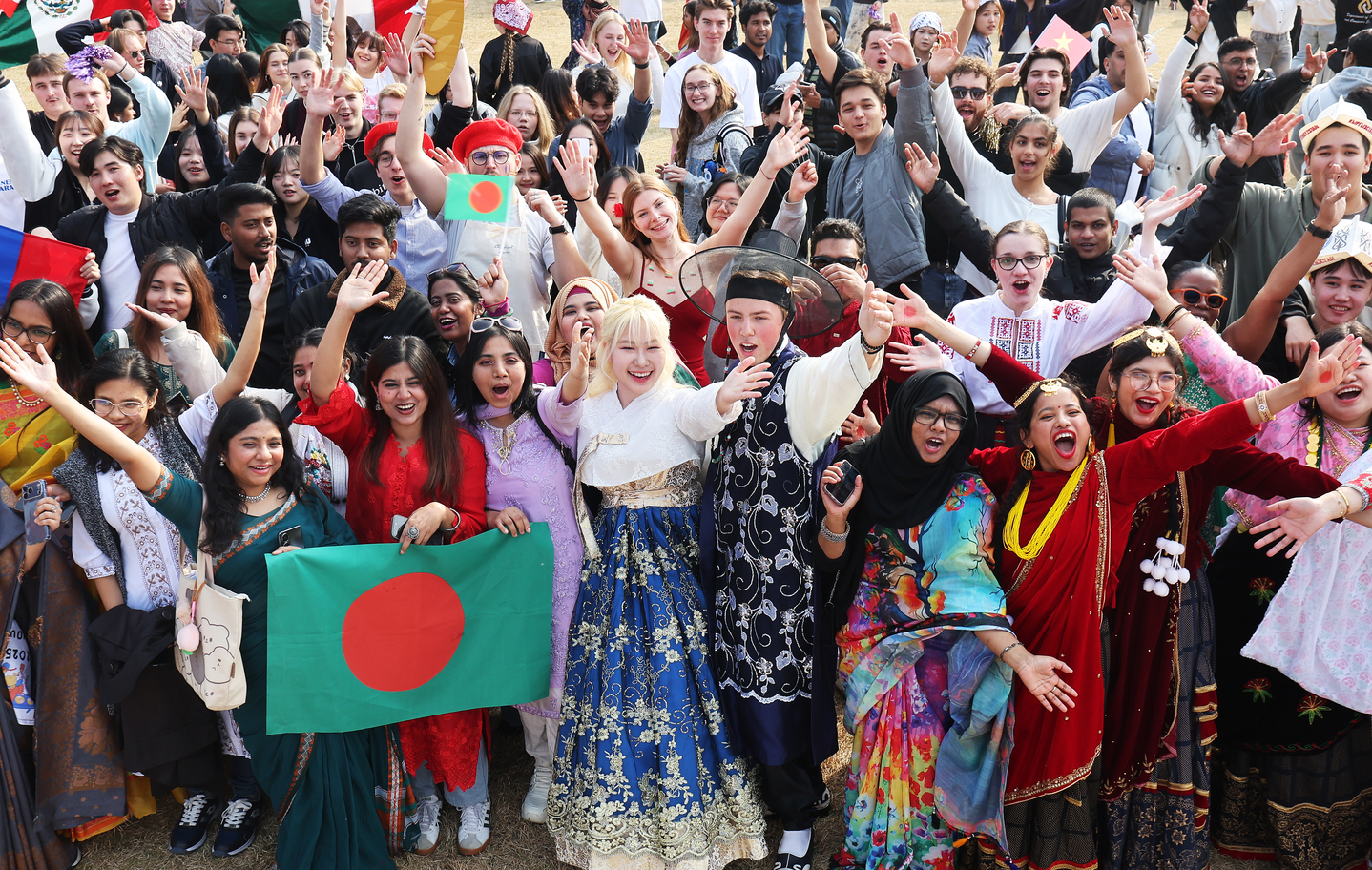 International students dressed in their country's traditional costumes pose for a photo and enjoy themselves during Ajou International Day 2025 at Ajou University in Suwon, Gyeonggi, on Nov. 6. [YONHAP]