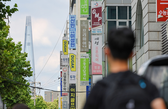Hagwon (private tutoring institute) signs are seen outside a building in Dogok-dong, southern Seoul, on July 23, 2025. [WOO SANG-JO]