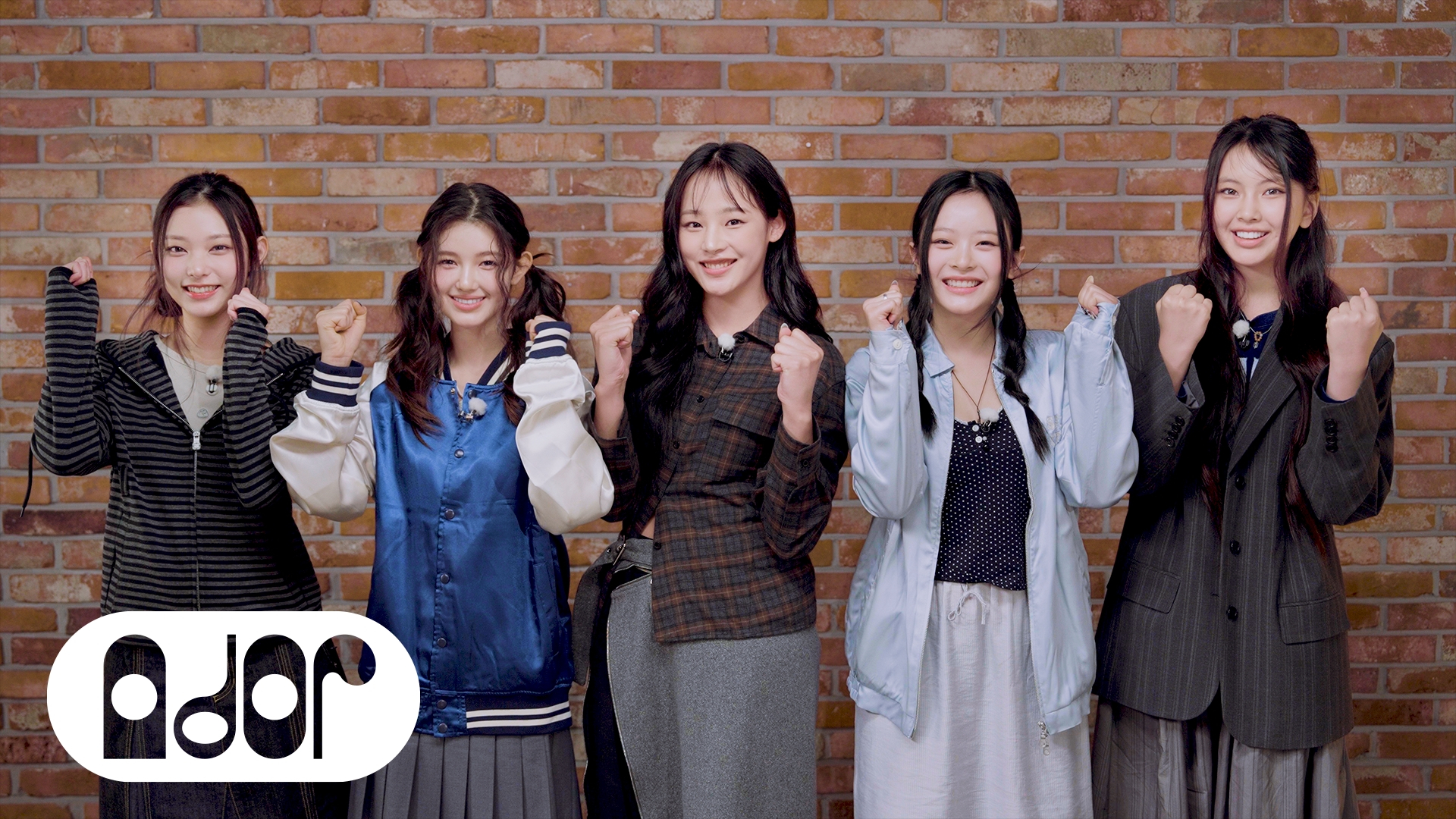 NewJeans members cheer for students taking the CSAT in the group's YouTube video. [ADOR]