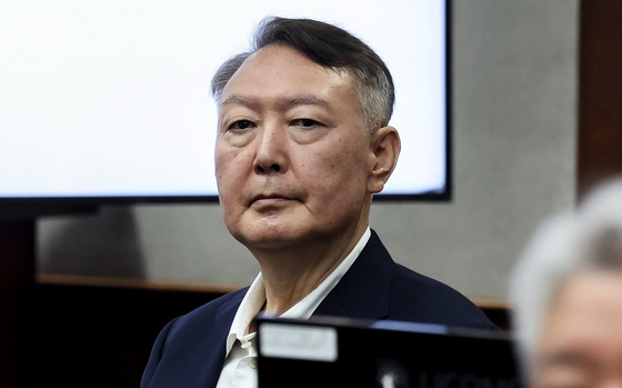 Former President Yoon Suk Yeol attends his trial on charges related to his December 2024 bid to impose martial law at the Seoul Central District Court in the capital, in this file photo from Sept. 26. [YONHAP] 