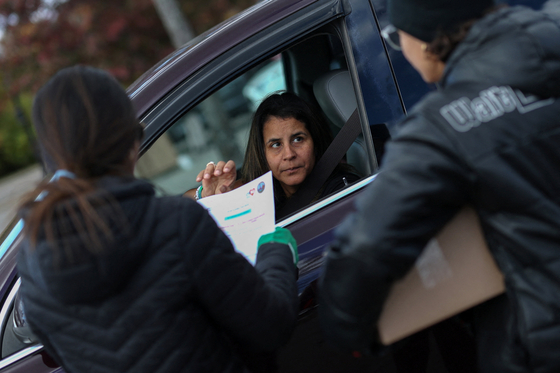 A woman checks in with volunteers loading boxes of food into her car during an event held by the Community FoodBank of New Jersey in partnership with Bergen County to deliver emergency food relief to Federal workers and SNAP recipients amid the U.S. government shutdown in Leonia, New Jersey, U.S., Nov. 6. [REUTERS/YONHAP]