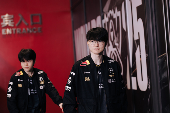 Esports player Faker of SKT T1, right, walks into the arena at the League of Legends (LoL) World Championship held at Dong'an Lake Sports Park in Chengdu, China, on Nov. 9. [RIOT GAMES]