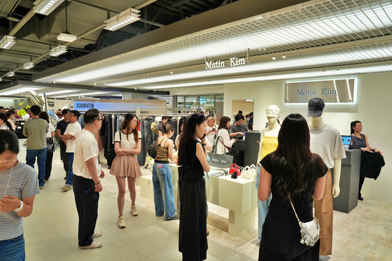 Shoppers look around a fashion-dedicated wing at Lotte Department Store's flagship branch in Myeongdong in Jung District, central Seoul, on July 4. [NEWS1] 