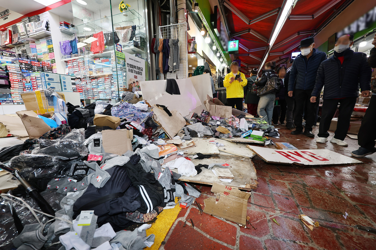 Clothes are scattered on the floor in Jeil Market, a traditional market in Bucheon, Gyeonggi, where a truck caused a crash on Nov. 13. [YONHAP]