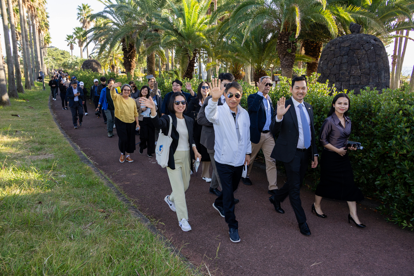 Participants wave at the camera while walking along the ASEAN-Korea Olle Trail, viewing the 10 newly completed ASEAN benches on Nov. 11. [ASEAN-KOREA CENTRE]