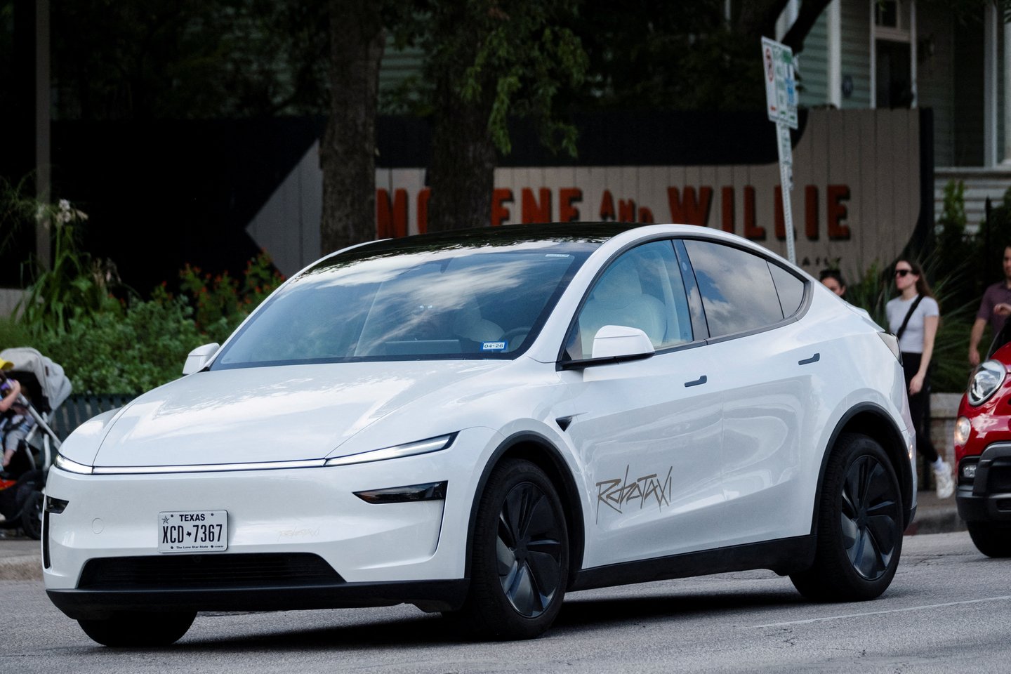 A Tesla robotaxi drives on the street along South Congress Avenue in Austin, Texas, on June 22. [REUTERS/YONHAP]