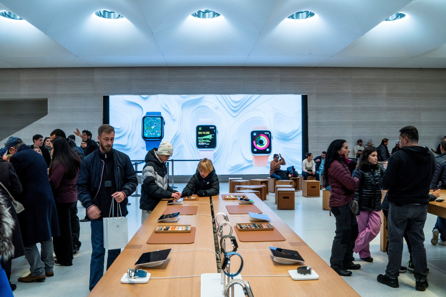 Apple smartwatches ads are displayed as customers visit the Apple store in New York City on Dec. 26. 2023. [REUTERS/YONHAP] 